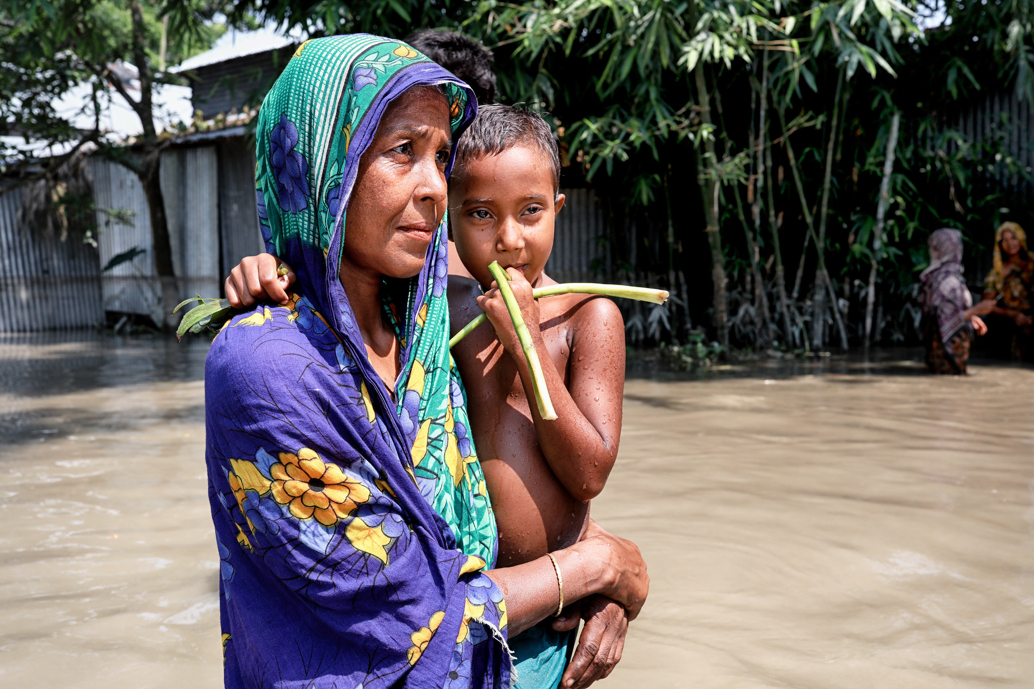 A woman flees her home in the midst of last year’s floods in Bangladesh. The ongoing floods this year are worse. UN Women Asia and the Pacific